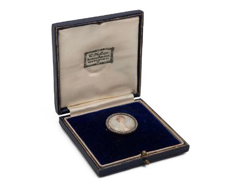 An 18ct gold backed (tested) circular brooch depicting&nbsp; miniature portrait of a young lady on ivory set within a diamond
