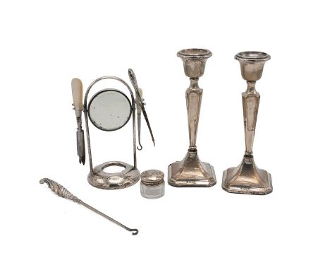 Silver dressing table set with swing mirror on stand and four manicure items, pair of weighted candlesticks, H17.5cm and a sh