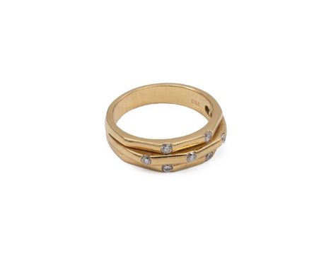 Yellow metal Diamond ring stamped 750 with a three band mount, the central band set with three diamonds flanked by four diamo