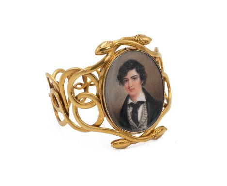 An 18ct gold (tested) bangle, of intricate detail in the form of two entwined serpents, bearing an oval miniature of a 19th c