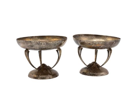 Pair of silver hammered, arts and crafts tazzas with stylised stem supports on a conical base, hallmarked Glasgow, 1909, make