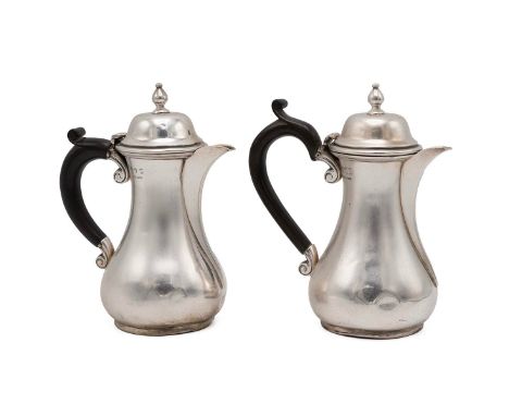 Pair of Irish silver hallmarked chocolate pots of baluster form, with scrolled bakelite handles and turned finials, hallmarke