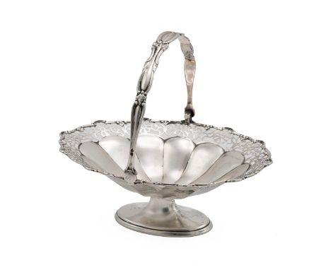 Silver sweetmeat basket with swing handle and a pierced floral rim raised on a pedestal oval foot, hallmarked Birmingham date