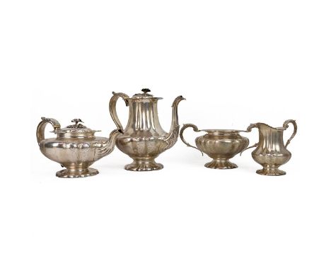 Georgian Silver & gilt lined four piece coffee/tea service, the coffee pot and tea pot with floral finial with shaped floral 