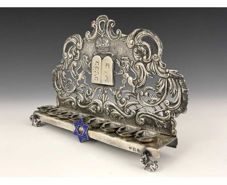 A Russian silver coloured metal Hanukkah lamp, ensuite with eight oil fonts, applied Star of David in blue enamel and small o
