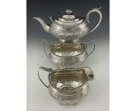 A George III Regency silver tea service, comprising teapot, sugar bowl and milk jug, each of ovoid form, decorated with shell