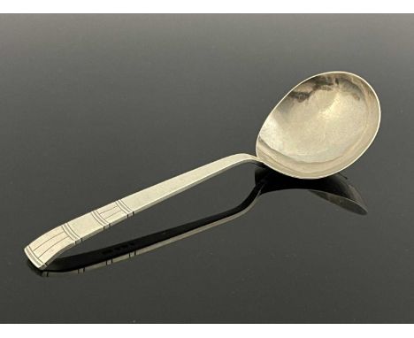 Bernard Cuzner, a large Arts and Crafts silver spoon, London 1943, planished ladle form bowl, incised banding to the finial, 