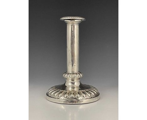 A George III silver single candlestick, with loaded circular fluted base, the underside with baize lining, the detachable noz