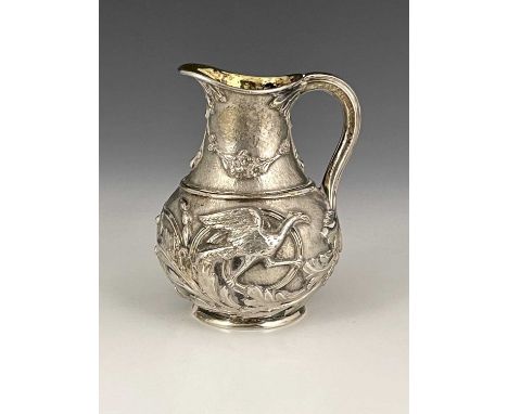 A Victorian silver Aesthetic style cream or milk jug, of baluster form, the body with Japonesque style decoration depicting t