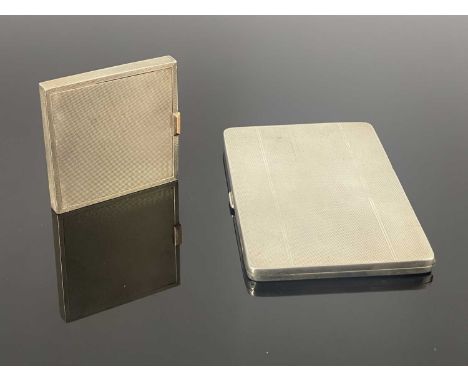 A George VI silver compact, the exterior decorated with engine-turning, the gold-coloured metal sprung thumbpiece to the cove