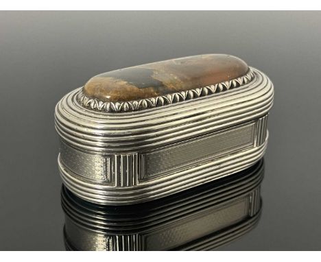 A George IV silver snuff box, of ovoid form, the cover inset with a polished cabochon specimen agate within a lotus style bor