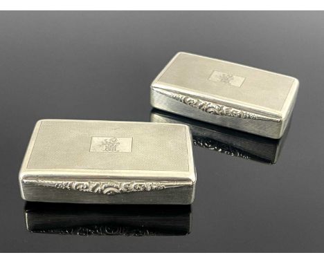 A pair of Elizabeth II silver snuff boxes, each of rectangular form with engine turned and reeded decoration, each engraved w