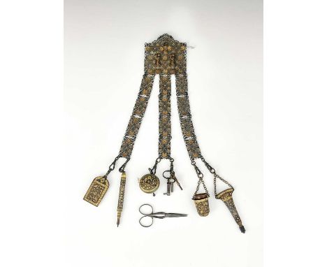 A nineteenth century Anglo Indian Grand Tour chatelaine, base metal, three lanyards of oxidised and gilt filigree panels susp