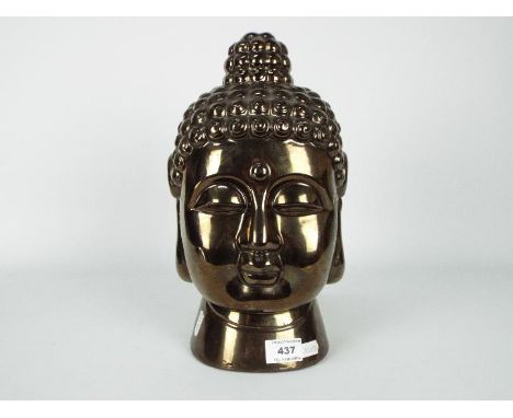 An Asian, bronzed ceramic Buddha head, approximately 30 cm (h).