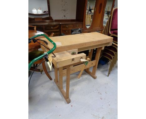 A twentieth century wooden work bench fitted with vices 