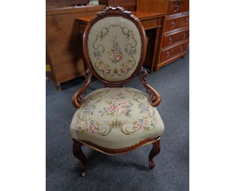 A walnut framed lady's chair upholstered in a floral tapestry fabric 
