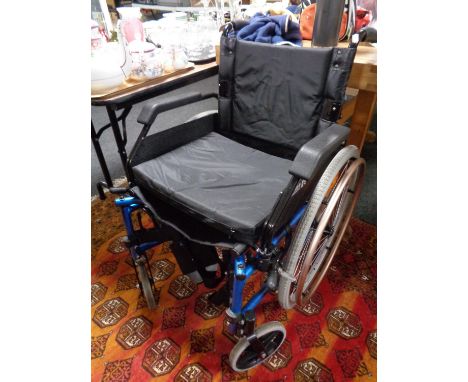 A folding Roma medical light weight wheel chair 