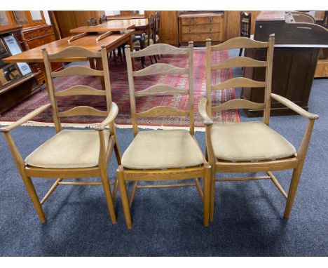 A set of six Ercol elm ladder backed dining chairs comprising of two carvers, four singles.