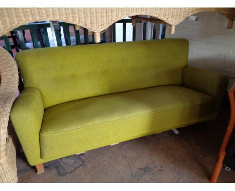 A mid century settee in light green fabric 