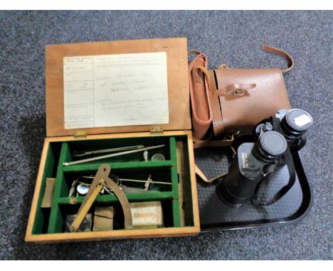 A wooden box of optometrist items, two pairs of binoculars, vintage camera etc 