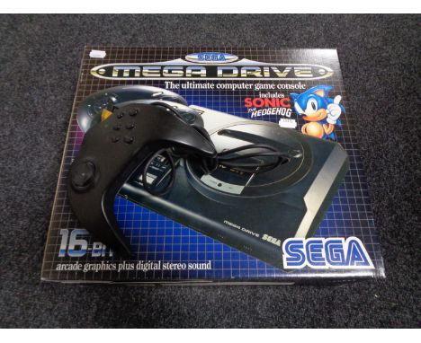 A boxed Sega Megadrive console together with additional Maxfire joy pad 