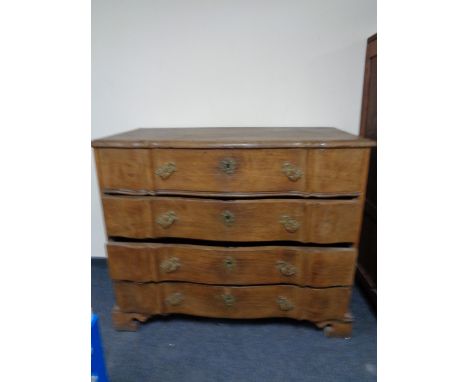 A nineteenth century oak serpentine fronted chest on bracket feet 