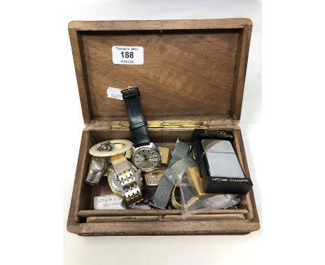 A trinket box containing Seiko and other watches, lighters including Dunhill and Zippo, white metal rattle etc