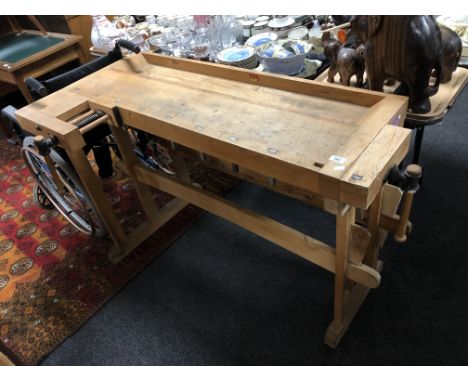 A twentieth century wood working bench fitted with vices  CONDITION REPORT: DIMENSIONS : 140 cm length, 72 cm depth, 80 cm he