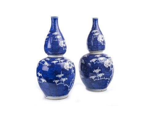 PAIR OF EARLY 20TH CENTURY CHINESE BLUE AND WHITE VASES, painted with blossom, double ring to base, 26cm high