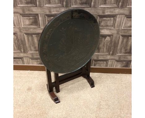 20TH CENTURY CHINESE FOLDING TABLE, the circular top carved in relief with sailing ships, 60cm diameter, along with a standar