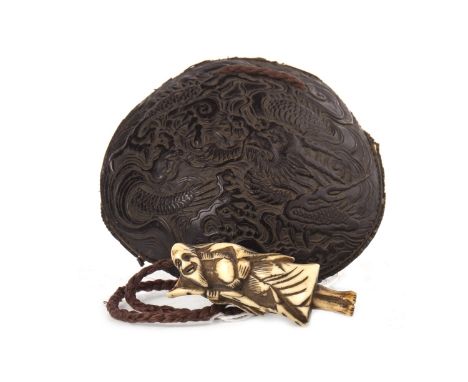 EARLY 20TH CENTURY JAPANESE TORTOISESHELL AND LEATHER POUCH, carved with a dragon amongst clouds, with a hardstone ojime bead