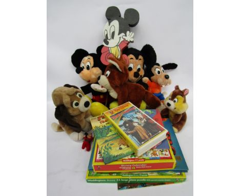 A collection of Disney items including vintage books, jigsaws and soft toys 