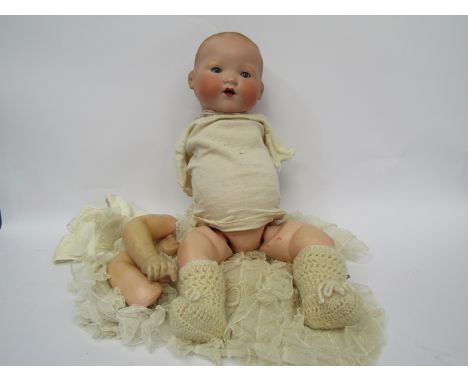 An Armand Marseille 351/8.K bisque head baby doll on jointed composition body (arms detached) approx 49cm tall