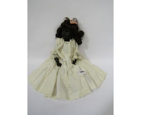 A black painted bisque head girl doll, head stamped R.OA Germany 