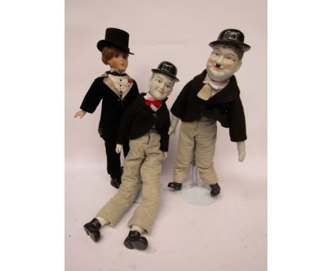 A pair of bisque head Laurel &amp; Hardy dolls and a boy doll in formal dress (3) 