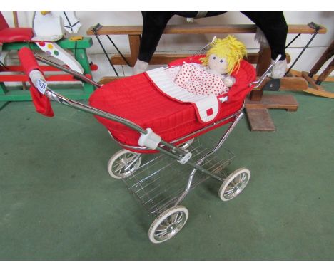 A vintage doll's pram and doll 