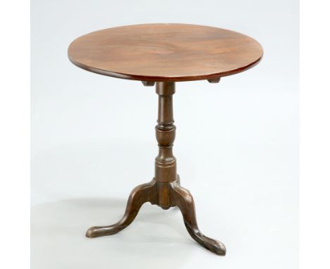 A GEORGE III MAHOGANY TRIPOD TABLE, the circular top raised on a turned stem continuing to hipped downswept legs terminating 