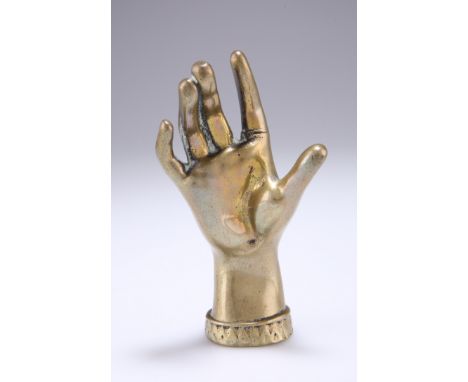 A VICTORIAN BRASS RING STAND, in the form of a hand. 12cm high