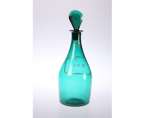 AN EARLY 19TH CENTURY GREEN GLASS RUM DECANTER, with gilded label, the flattened tear-drop stopper gilded to each side with a