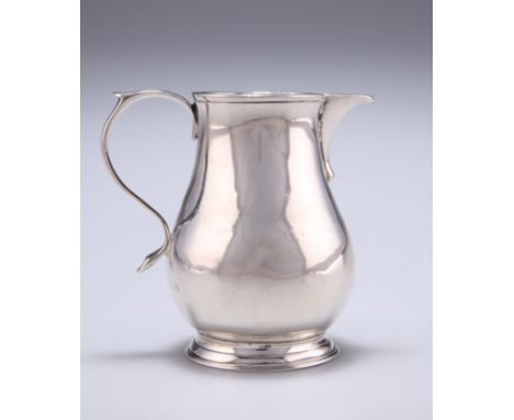 A GEORGIAN SILVER CREAM JUG, possibly by James Stone, maker's mark only, of small baluster form, with S-scroll handle and spa