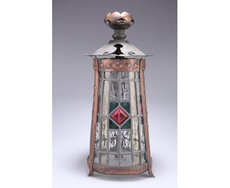 AN ARTS AND CRAFTS COPPER LANTERN, tapering cylindrical form, the three lead-glazed panels centred by a pink stained glass lo