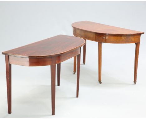 ~ TWO GEORGE III MAHOGANY DEMILUNE SIDE TABLES, the first with satinwood banded edge and square-sectional tapered legs, the s