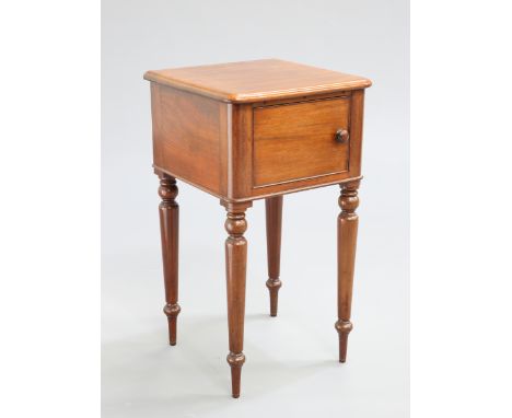 A VICTORIAN MAHOGANY POT CUPBOARD, the top with rounded corners above a cupboard door with turned pull, raised on baluster le