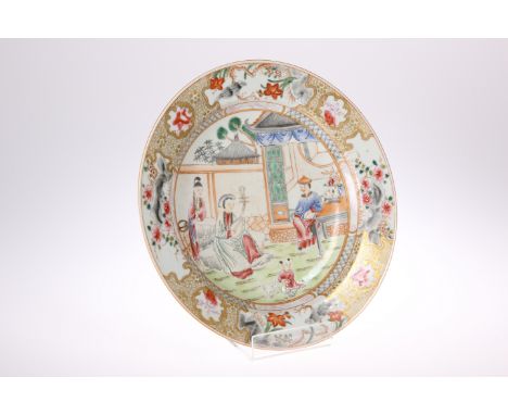 A CHINESE FAMILLE ROSE DISH, circular, enamel painted with a family in a garden, within a border painted with four panels of 