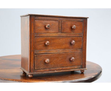 A GEORGIAN OAK SPOON RACK, with arched top and two tiers for hanging, the base with open box; together with A VICTORIAN MINIA