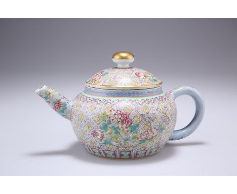 A CHINESE FAMILLE ROSE TEAPOT, of squat form, densely enamel painted with foliage, bears underglaze blue seal mark against a 