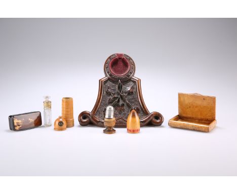 TREEN: A GROUP OF TREEN, including a thimble case, containing a silver-plated thimble; a lighthouse-form scent bottle case, c