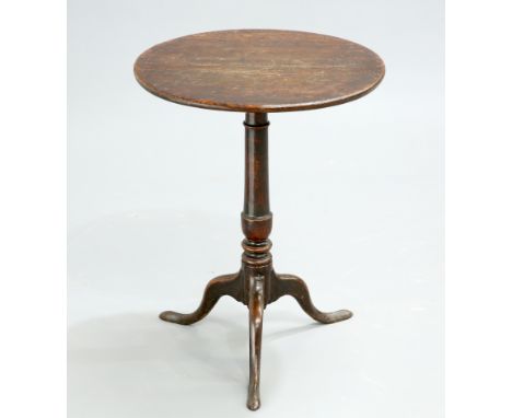 A GEORGE III OAK TILT-TOP TRIPOD TABLE, the circular top raised on a turned stem continuing to hipped downswept legs terminat