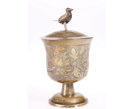 A CHINESE SILVER CUP AND COVER, marked L (over) KK, the slightly domed cover with bird-form finial, chased with foliage. 12cm