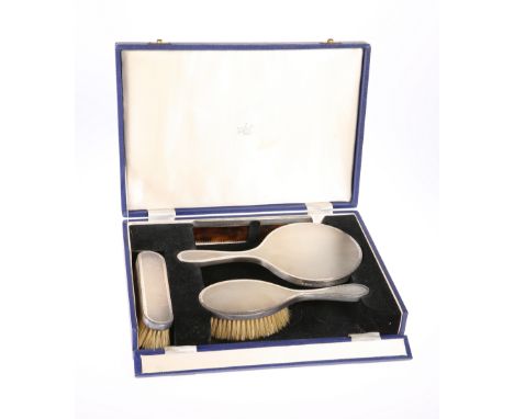 AN ELIZABETH II SILVER FOUR PIECE DRESSING TABLE SET, London 1964, comprising two brushes, mirror and comb, each with engine 